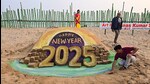 Puri, Dec 31 (ANI): Sand artist Manas Kumar Sahoo makes a sand art wishing New Year 2025, at Puri beach in Puri on Wednesday. (ANI Photo) (Prahlad Mahato)