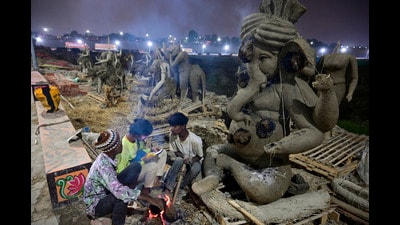 Artists sit around a bonfire to keep themselves warm on a cold and foggy day ahead of the Mahakumbh 2025, at Sangam in Prayagraj on December 31, 2024. (PTI) Artists sit around a bonfire to keep themselves warm on a cold and foggy day ahead of the Mahakumbh 2025, at Sangam in Prayagraj on December 31, 2024. (PTI)