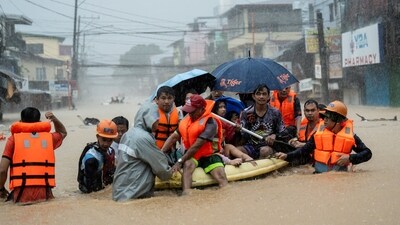 Rescuers assist residents on a boat as they wade through a flooded road following heavy rains brought by Typhoon Gaemi, in Marikina City, Metro Manila, Philippines, July 24, 2024. (REUTERS)