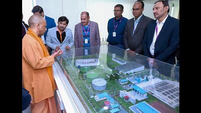 Chief minister Yogi Adityanath inspects the miniature model of bio CNG plant, in Prayagraj on Tuesday. (ANI Photo) Chief minister Yogi Adityanath inspects the miniature model of bio CNG plant, in Prayagraj on Tuesday. (ANI Photo)