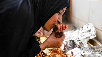 A mother's farewell to the body of her child who was killed in the aftermath of overnight Israeli bombardment in al-Maghazi in the central Gaza Strip, at the morgue of the Aqsa Martyrs hospital in Deir el-Balah on June 25, 2024 amid the ongoing conflict in the Palestinian territory between Israel and Hamas. (AFP) A mother's farewell to the body of her child who was killed in the aftermath of overnight Israeli bombardment in al-Maghazi in the central Gaza Strip, at the morgue of the Aqsa Martyrs hospital in Deir el-Balah on June 25, 2024 amid the ongoing conflict in the Palestinian territory between Israel and Hamas. (AFP)