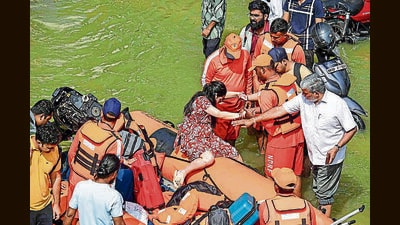 NDRF personnel evacuate people from a flood-affected are in Bengaluru in October. (ANI) NDRF personnel evacuate people from a flood-affected are in Bengaluru in October. (ANI)