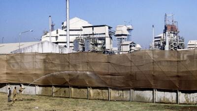 People spray water on the Union Carbide factory premises following a gas leak disaster in Bhopal on December 4, 1984. (AFP FILE) People spray water on the Union Carbide factory premises following a gas leak disaster in Bhopal on December 4, 1984. (AFP FILE)