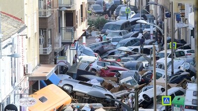 Pedestrians stand next to piled up cars following deadly floods in Sedavi, south of Valencia, eastern Spain, on October 30, 2024.. Floods triggered by torrential rains in Spain's eastern Valencia region left at least 70 people dead. (AFP) Pedestrians stand next to piled up cars following deadly floods in Sedavi, south of Valencia, eastern Spain, on October 30, 2024.. Floods triggered by torrential rains in Spain's eastern Valencia region left at least 70 people dead. (AFP)