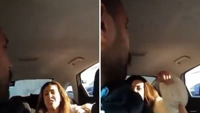 The image shows an altercation between a woman and a cab driver. (X) The image shows an altercation between a woman and a cab driver. (X)