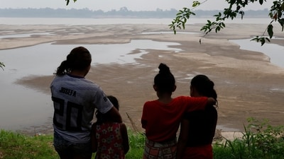 Residents look out at the Madeira River, a tributary of the Amazon River amid a drought in Humaita, Amazonas state, Brazil, Sept. 7, 2024. (AP) Residents look out at the Madeira River, a tributary of the Amazon River amid a drought in Humaita, Amazonas state, Brazil, Sept. 7, 2024. (AP)
