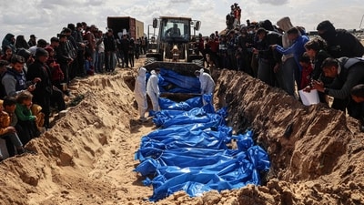 Mourners watched as medical personnel prepared the bodies of 47 Palestinians that were taken and later released by Israel during a mass funeral in Rafah, in the southern Gaza Strip, on March 7, 2024, amid ongoing battles between Israel and the Palestinian militant group Hamas. (AFP) Mourners watched as medical personnel prepared the bodies of 47 Palestinians that were taken and later released by Israel during a mass funeral in Rafah, in the southern Gaza Strip, on March 7, 2024, amid ongoing battles between Israel and the Palestinian militant group Hamas. (AFP)