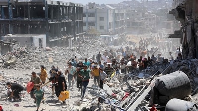 Palestinians who returned briefly to the Jabalia refugee camp in the northern Gaza Strip to check on their homes, ran for cover after a school was hit by an Israeli strike on May 30, 2024, amid the ongoing conflict between Israel and the militant group Hamas. (AFP) Palestinians who returned briefly to the Jabalia refugee camp in the northern Gaza Strip to check on their homes, ran for cover after a school was hit by an Israeli strike on May 30, 2024, amid the ongoing conflict between Israel and the militant group Hamas. (AFP)