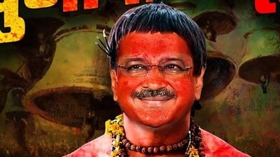 Delhi BJP's poster depicts Arvind Kejriwal adorned with rudraksha beads, flower garlands, and vermilion covering his body. Delhi BJP's poster depicts Arvind Kejriwal adorned with rudraksha beads, flower garlands, and vermilion covering his body.