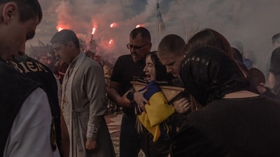 Mariana (C) reacts during the funeral of her son Nazary Gryntsevych, a Ukrainian soldier of the Azov Brigade callsign "Grinka", at a cemetery in Vinnytsia, on May 10, 2024, amid the Russian invasion of Ukraine. "Grinka" was one of the youngest soldiers to hold the Azovstal steel plant in the southern city of Mariupol during a three-month-long siege that gave its defenders a cult status, before being captured by Russian troops when they seized Mariupol in May 2022, before being repatriated to Ukraine as part of a prisoner deal with Russia before once again returning to the battlefield where he was later killed. (AFP) Mariana (C) reacts during the funeral of her son Nazary Gryntsevych, a Ukrainian soldier of the Azov Brigade callsign "Grinka", at a cemetery in Vinnytsia, on May 10, 2024, amid the Russian invasion of Ukraine. "Grinka" was one of the youngest soldiers to hold the Azovstal steel plant in the southern city of Mariupol during a three-month-long siege that gave its defenders a cult status, before being captured by Russian troops when they seized Mariupol in May 2022, before being repatriated to Ukraine as part of a prisoner deal with Russia before once again returning to the battlefield where he was later killed. (AFP)