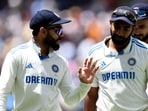 India's  Virat Kohli (L) chats to Jasprit Bumrah as they leave the field for the lunch break on day four of the fourth cricket Test match between Australia and India at the Melbourne Cricket Ground (MCG)