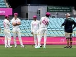 Australian captain Pat Cummins (2nd L) inspects the pitch area with teammates ahead of the fifth cricket Test match at the Sydney Cricket Ground in Sydney.