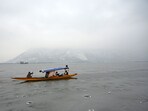 Tourists enjoying shikara boat ride on a frozen surface of Dal Lake in Srinagar on Wednesday. (Waseem Andrabi /HT)