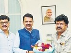 Walmik Karad (R) accompanied Dhananjay Munde (L) when the latter went to meet Devendra Fadnavis (C) after he was sworn in as chief minister.