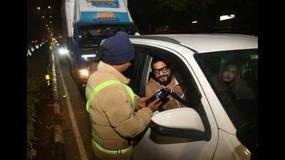 A cop conducts a breathalyser test to check drunk driving in Chandigarh on Tuesday. (Keshav Singh/HT) A cop conducts a breathalyser test to check drunk driving in Chandigarh on Tuesday. (Keshav Singh/HT)