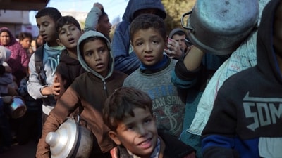 Palestinian children queue for food in Deir al-Balah, Gaza Strip, Dec. 13, 2024. (AP)