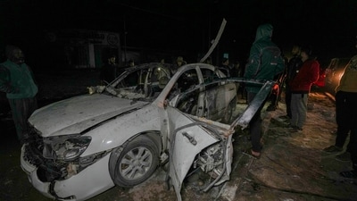 Palestinians inspect a car after it was hit by an Israeli airstrike killing four people in Deir al-Balah, central Gaza Strip, Dec. 23, 2024. (AP)