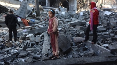Children inspect the damage at the site of an Israeli strike in Jabalia. (AFP)