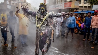 An artist dressed as Lord Shiva takes part in a religious procession on the occasion of 'Rangbhari Ekadashi', in Varanasi, March 20, 2024. (PTI) An artist dressed as Lord Shiva takes part in a religious procession on the occasion of 'Rangbhari Ekadashi', in Varanasi, March 20, 2024. (PTI)