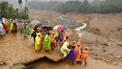 Wayanad : Rescue workers carry the body of a victim as search operations continue following landslides in Mundakai, Chooralmala area. (PTI/Binu) Wayanad : Rescue workers carry the body of a victim as search operations continue following landslides in Mundakai, Chooralmala area. (PTI/Binu)