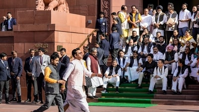 BJP MP Ravi Kishan walks by as opposition MPs stage a protest during the Winter session of Parliament, in New Delhi, Dec. 5, 2024. In an unusual protest, leaders of several INDIA bloc parties wore black jackets with stickers reading "Modi Adani Ek Hai" and "Adani Safe Hai" on them and raised slogans on the Parliament premises to demand a joint parliamentary probe into the Adani issue. (PTI/Vijay Verma) BJP MP Ravi Kishan walks by as opposition MPs stage a protest during the Winter session of Parliament, in New Delhi, Dec. 5, 2024. In an unusual protest, leaders of several INDIA bloc parties wore black jackets with stickers reading "Modi Adani Ek Hai" and "Adani Safe Hai" on them and raised slogans on the Parliament premises to demand a joint parliamentary probe into the Adani issue. (PTI/Vijay Verma)