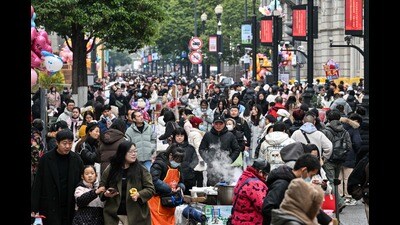 People walk on a pedestrian street in Wuhan, in China's central Hubei province on December 22, 2024, ahead of the fifth anniversary of China confirming its first death from the Covid-19 coronavirus. (Photo by Hector RETAMAL / AFP) (AFP) People walk on a pedestrian street in Wuhan, in China's central Hubei province on December 22, 2024, ahead of the fifth anniversary of China confirming its first death from the Covid-19 coronavirus. (Photo by Hector RETAMAL / AFP) (AFP)