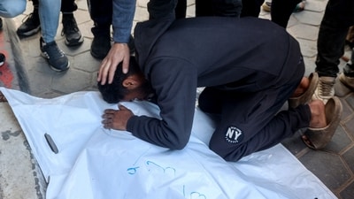 A man mourns over the bodies of a loved one killed in an Israeli strike on al-Meghazi refugee camp in the central Gaza Strip, at the Aqsa Martyrs hospital in Deir el-Balah on December 28, 2024. (AFP/Eyad Baba)