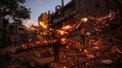 Children play with fireworks at the Bureij camp for displaced Palestinians on December 30, 2024. Since the war between Israel and Hamas began in October last year, Gaza's 2.4 million residents have endured severe shortages of electricity, drinkable water, food and medical services.&nbsp; (AFP/Eyad Baba)