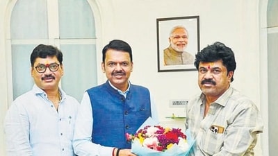 Walmik Karad (R) accompanied Dhananjay Munde (L) when the latter went to meet Devendra Fadnavis (C) after he was sworn in as chief minister. Walmik Karad (R) accompanied Dhananjay Munde (L) when the latter went to meet Devendra Fadnavis (C) after he was sworn in as chief minister.