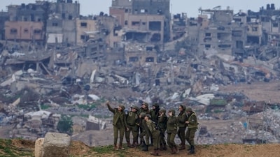 Israeli female soldiers pose for a photo on a position on the Gaza Strip border, in southern Israel, Feb. 19, 2024.&nbsp; (AP/Tsafrir Abayov)