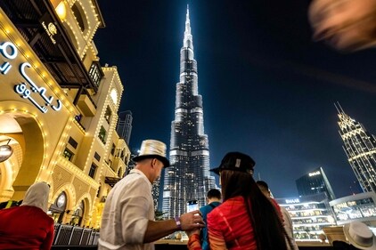 Revellers watch the lit up Burj Khalifa, the world's tallest building, ahead of New Year's Eve celebrations in Dubai on December 31, 2024. (AFP) Revellers watch the lit up Burj Khalifa, the world's tallest building, ahead of New Year's Eve celebrations in Dubai on December 31, 2024. (AFP)