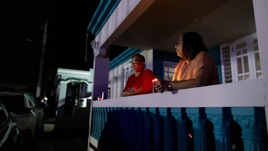 Residents hold candles on New Year's Eve during a blackout (Bloomberg)
