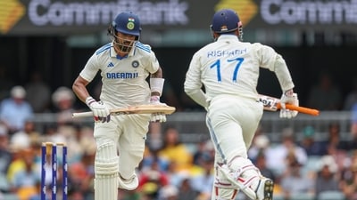 India's KL Rahul, left, and Rishabh Pant run between the wickets to score during play on day three of the third cricket test between India and Australia at the Gabba (AP)