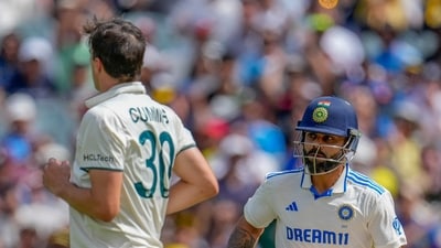 India's Virat Kohli run between the wickets to score as Australia's captain Pat Cummins looks on. (AP) India's Virat Kohli run between the wickets to score as Australia's captain Pat Cummins looks on. (AP)