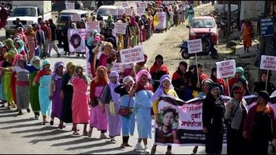 Demonstrators hold placards as they take part in a protest rally (REUTERS) Demonstrators hold placards as they take part in a protest rally (REUTERS)