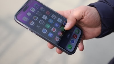 An Iranian man looks at his mobile phone after the ban on WhatsApp and Google Play was lifted. (REUTERS)