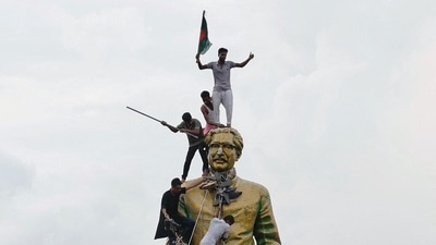 A file photo of protesters atop the statue of Sheikh Mujibur Rahman at the Bijoy Sarani area, as they celebrate the resignation of the Prime Minister Sheikh Hasina in Dhaka on August 5. (Mohammad Ponir Hossain/Reuters file)