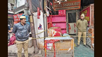 Police personnel during an investigation after five members of a family were found dead at a hotel, in Lucknow (PTI) Police personnel during an investigation after five members of a family were found dead at a hotel, in Lucknow (PTI)