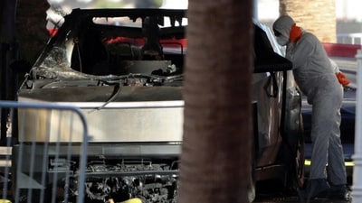 The remains of a Tesla Cybertruck that burned at the entrance of Trump Tower are inspected in Las Vegas, Nevada, US, on January 1, 2025. (REUTERS)