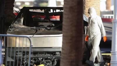 The remains of a Tesla Cybertruck that burned at the entrance of Trump Tower, are inspected in Las Vegas, Nevada, U.S. January 1, 2025.  REUTERS