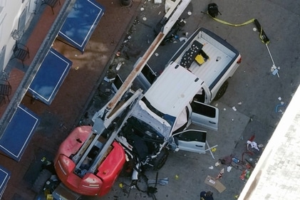 A black flag with white lettering lies on the ground rolled up behind a pickup truck that a man drove into a crowd on Bourbon Street in New Orleans, killing and injuring a number of people, early Wednesday morning, (AP) A black flag with white lettering lies on the ground rolled up behind a pickup truck that a man drove into a crowd on Bourbon Street in New Orleans, killing and injuring a number of people, early Wednesday morning, (AP)