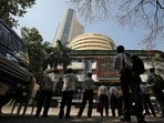 Stock market crash: People look at a screen displaying the Sensex results on the facade of the Bombay Stock Exchange (BSE) building in Mumbai.