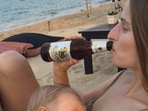 Olga Vlachynská shared a LinkedIn picture which shows her breastfeeding while drinking a beer