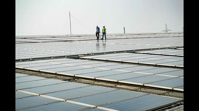 (FILES) This photograph taken on November 21, 2024 shows employees at SunSource Energy inspecting solar panels installed at a food processing plant of the Indian food service company Jubilant FoodWorks in Greater Noida. (Photo by Money SHARMA / AFP) (AFP) (FILES) This photograph taken on November 21, 2024 shows employees at SunSource Energy inspecting solar panels installed at a food processing plant of the Indian food service company Jubilant FoodWorks in Greater Noida. (Photo by Money SHARMA / AFP) (AFP)