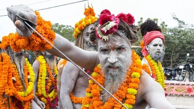 A saint of Shri Panchayati Mahanirvani Akhara displays a sword during a religious procession on the first Royal Entry 'Chavni Pravesh' for the Maha Kumbh Mela 2025, in Prayagraj. (ANI)