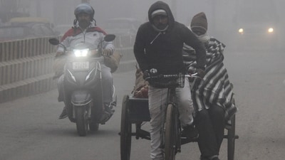 A rickshaw puller plies on a road amid fog on a frizzy morning, in Gurugram on Thursday. (ANI)