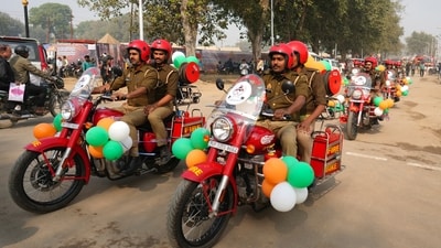Firefighters on motorcycles decorated with balloons ride through the town in a public relations exercise before the upcoming Maha Kumbh Mela, in Prayagraj. (AP)