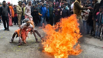 Artists perform during the 'Chavni Pravesh' by 'sadhus' of 'Shree Mahanirvani Akhada', the royal entry procession for Maha Kumbh Mela 2025, at Sangam in Prayagraj. (PTI)