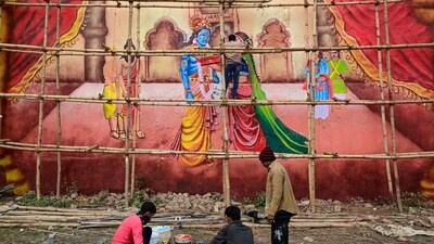 An artist paints a mural of Lord Krishna as part of preparations for Maha Kumbh Mela 2025, in Prayagraj. (PTI)