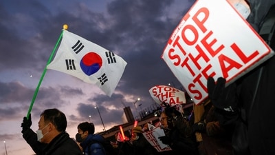 Pro-Yoon protesters hold South Korean flags and 'STOP THE STEAL' signs during a rally near impeached South Korean President Yoon Suk Yeol's official residence (REUTERS)